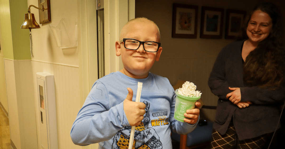 Boy with Shamrock Shake in hospital.